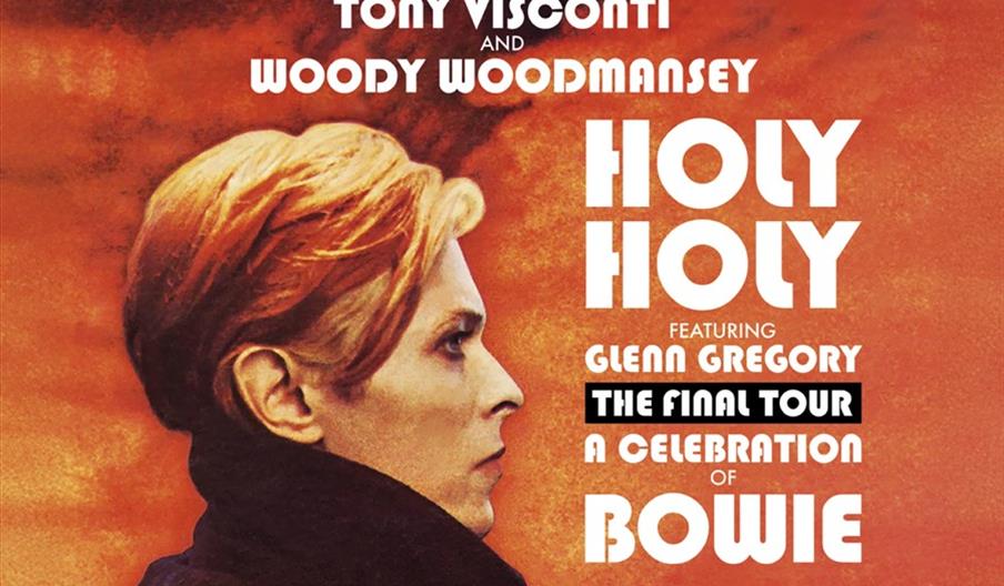 A promotional poster featuring a side profile of a person with blond hair and a black coat against an orange background, with bold white text announci