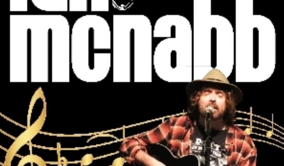 A man with long curly hair and a hat plays an acoustic guitar and sings into a microphone in front of musical notes, with the large text "Ian McNabb"