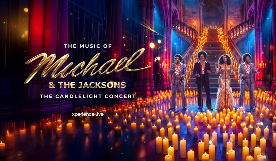 A theatrical scene with four performers in glamorous outfits singing on a stage lined with hundreds of glowing candles, set in an ornate cathedral wit