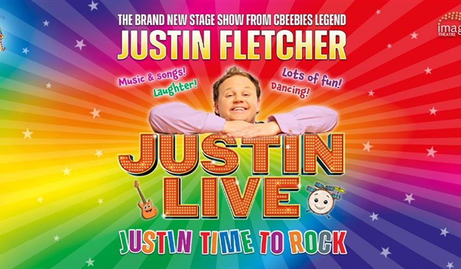 A promotional poster for "Justin Live: Justin Time to Rock" featuring Justin Fletcher smiling with his arms resting on a large, colorful "JUSTIN LIVE"