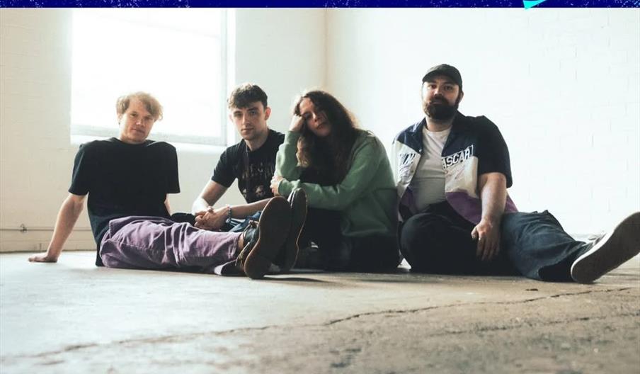Promotional poster for the "Everywhere at Once" event, powered by the National Lottery, featuring a photo of four band members from Long Island sittin