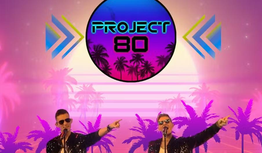 Two men wearing sunglasses and sequin jackets sing and point while standing in front of microphones, against a neon-lit 1980s-inspired background with