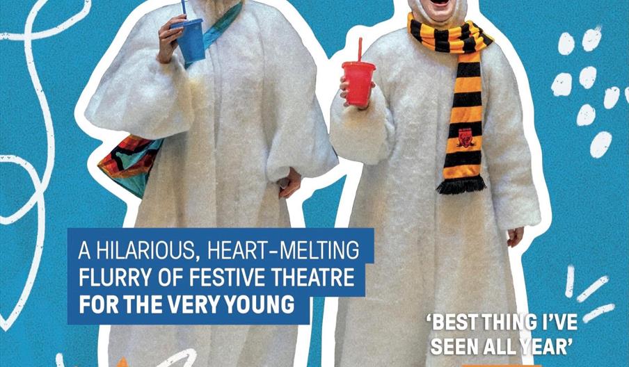 Two people dressed in white snowman costumes stand in front of a bright blue background, smiling and holding colorful drinks; one wears a striped yell