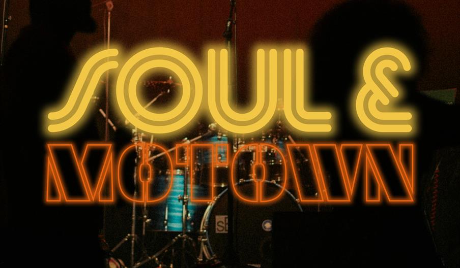 Silhouettes of two people stand in front of a stage with drums and microphones, overlaid with glowing yellow and orange neon-style text reading "SOUL