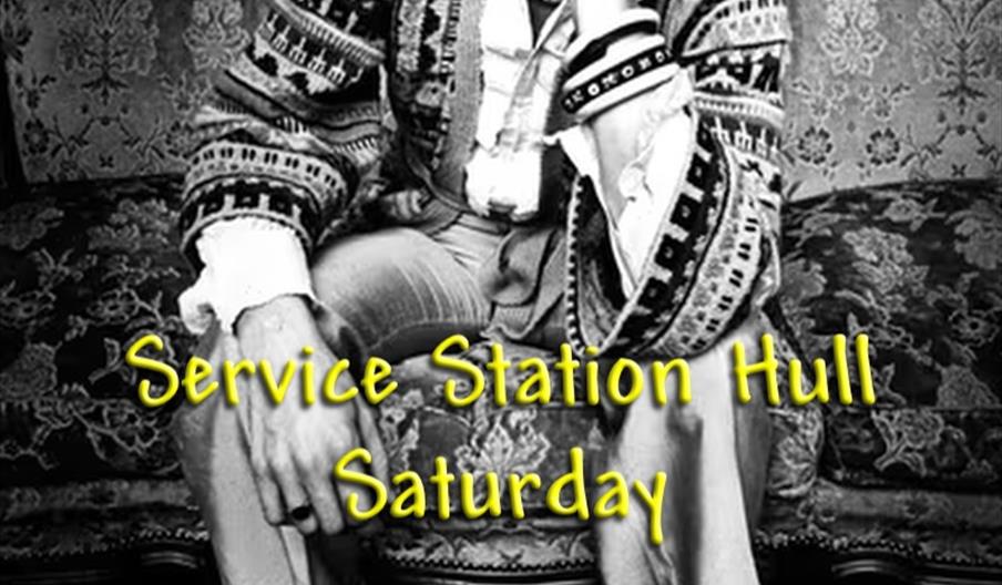 Promotional poster for Stikkyfingers.co.uk, a Rolling Stones tribute band, featuring a black and white photo of a man sitting on a vintage sofa, with