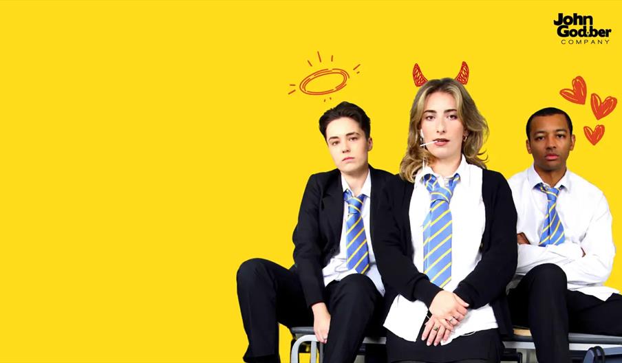 Three young people in school uniforms sit against a bright yellow background. The student in the middle has cartoon devil horns, the one on the left h
