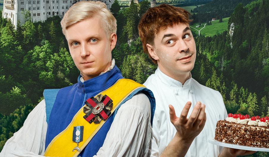 A finely dressed blonde prince stands with his arms crossed next to a man dressed as a baker who shrugs whilst holding a chocolate cake. Behind them i