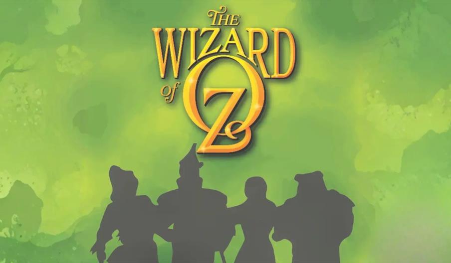 The image shows the title "The Wizard of Oz" in large yellow letters against a green background, with silhouettes of four characters standing beneath