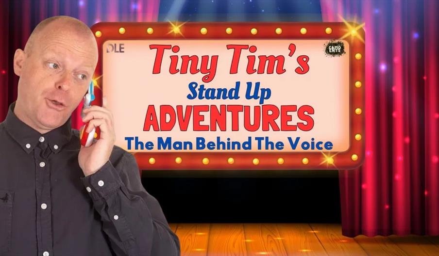 A man with short hair holds a colorful phone to his ear while looking off to the side; behind him is a marquee-style sign with theater lights that rea