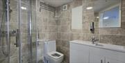 Fully tiled bathroom with shower.