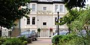 The main entrance to the Hotel framed by the planting in Kingston Square.