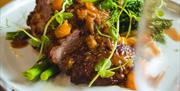 Braised beef short rib with seasonal greens and rich sauce.