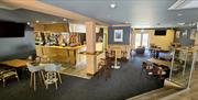 Bar area with stools and table seating
