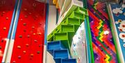 A series of multicoloured climbing walls and sculptures, one with a timer screen built in.