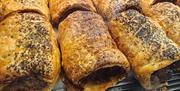 A Tray of freshly basked, flakey sausage rolls.
