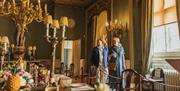 Two people stood inside the Dining Room at Burton Constable Hall.