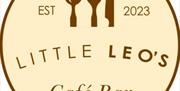Circular logo for "Little Leo's Café Bar" with a spoon, fork, and knife illustration at the top, "EST 2023" on either side, and the café name in bold