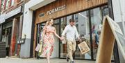 Couple walking hand in hand outside Form Shop & Studio