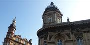 The Hull Maritime Museum building, showing ornate stone architecture and domed towers against a clear blue sky