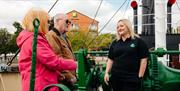 Guided tour on board the Spurn Lightship. 2 people are listening to information on the deck.
